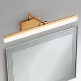 "A brushed gold LED vanity light mounted above a decorative bathroom mirror."