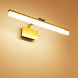 "A brushed gold LED vanity light emitting warm, ambient light on a textured wall."