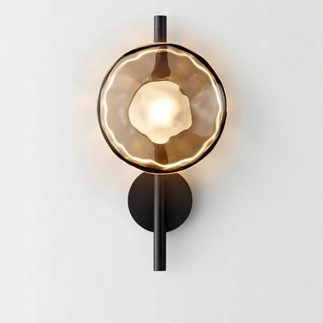 "Modern wall lamp with a smoked glass shade and a black vertical rod, providing a warm, ambient glow."