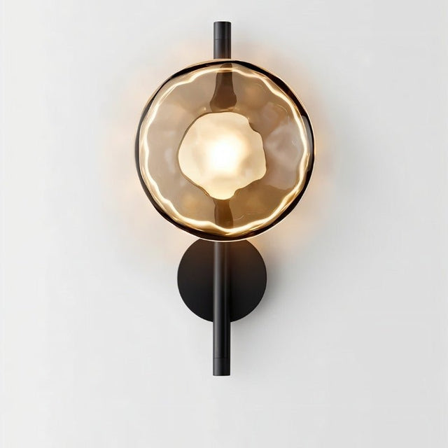 "Modern wall lamp with a smoked glass shade and a black vertical rod, providing a warm, ambient glow."