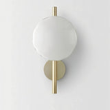 "Modern wall lamp with a round white glass shade and a vertical rod, providing soft, ambient lighting."