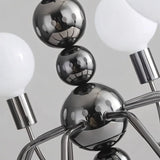 "Close-up of Walfi chandelier with iron frame and frosted glass globes showing detailed construction."