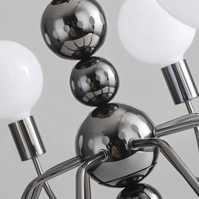 "Close-up of Walfi chandelier with iron frame and frosted glass globes showing detailed construction."