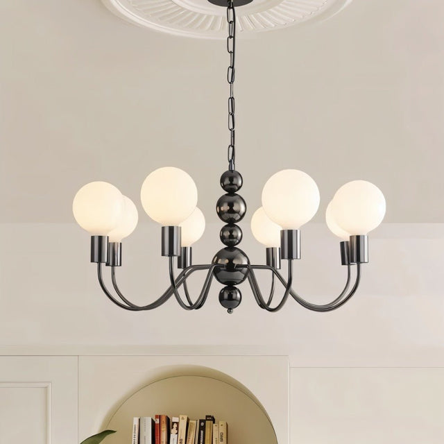 "Walfi chandelier with iron frame and frosted glass globes hanging in a living room with a bookshelf."