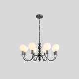 "Modern sculptural chandelier with a black iron frame, six curved arms, and frosted glass globes, providing soft ambient lighting."