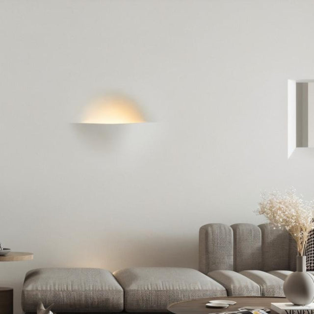 "Wiane trimless wall light illuminating a modern living room wall."
