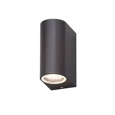 "Angled view of a modern outdoor wall lamp with a dark aluminum body and glass diffuser, showing its compact design."
