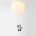 Pendant ceiling light with cream globe shade and black-and-white panda figurine hanging against white background.