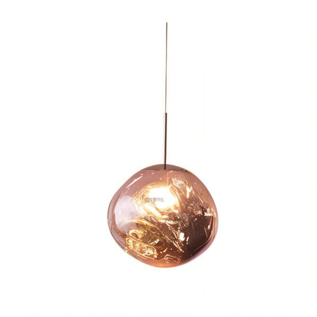 Copper pendant light with reflective globe shade and warm glow, hanging against white background.