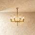 Wynlo Chandelier – bold copper chandelier with eight glass shades, perfect for ambient lighting in contemporary living spaces.