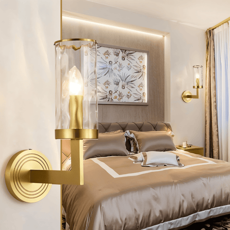 Wynlo Copper Walllamp installed in a stylish bedroom, providing soft ambient lighting beside a neatly made bed with neutral tones.