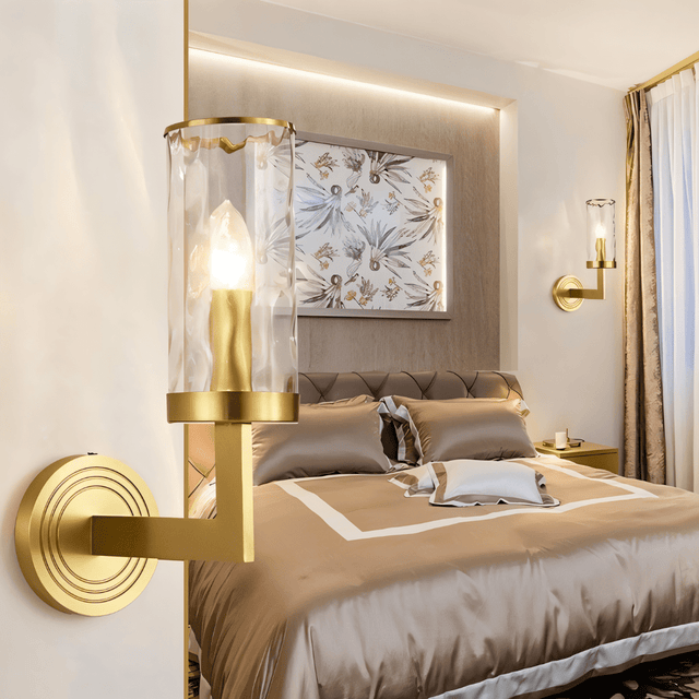 Wynlo Copper Walllamp installed in a stylish bedroom, providing soft ambient lighting beside a neatly made bed with neutral tones.