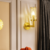 Wynlo Copper Walllamp mounted on a paneled wall near dark curtains, radiating warm ambient light in a sophisticated setting.