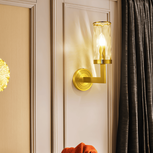 Wynlo Copper Walllamp mounted on a paneled wall near dark curtains, radiating warm ambient light in a sophisticated setting.