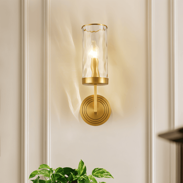 Front view of Wynlo Copper Walllamp with ripple glass shade, mounted on a white paneled wall above green indoor plants.