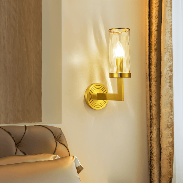 Wynlo Copper Walllamp beside a tufted headboard in a bedroom, offering warm ambient lighting through its ripple glass shade.