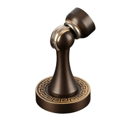 "Elegant, sculpted brass door stop with a tapered design, featuring a magnetic hold and a decorative base with intricate detailing, designed to prevent wall damage in modern and classic interiors."