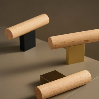 "Modern wood and brass knobs and pull bars, showcasing a minimalist design for contemporary cabinets and drawers."