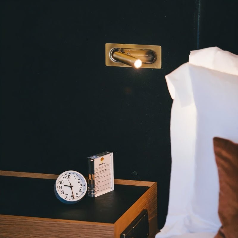 "Zarwa bedside reading lamp with a brass wall mount, featuring a sleek design and adjustable spotlight, made from durable metal and acrylic, ideal for bedside lighting."
