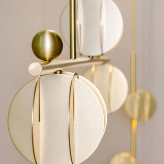 "Close-up of the Zarya pendant light showcasing detailed design, made from durable gold iron and aluminum alloy with modern minimalist features."