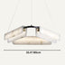 Marble pendant chandelier with curved white alabaster shades and black metal accents, suspended against a neutral background.