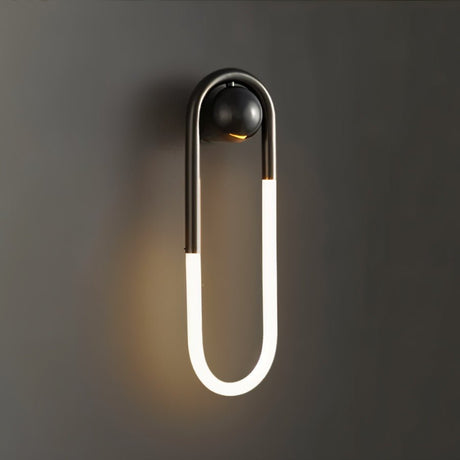 "A modern, minimalist U-shaped black wall lamp emitting a soft, warm light."