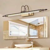 "A silver wall lamp with decorative end caps mounted above a bathroom vanity mirror, reflecting a window and shower, with a modern sink below."