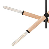 "Close-up of a modern pendant light with a cross-shaped design, showcasing the wood and iron details."