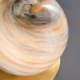 "Close-up of a modern table lamp with marble glass globe shade, showing the intricate details."