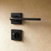 Two views of a stainless steel wall-mounted faucet spout with curved outlet, shown against white background.