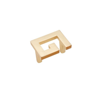 "A brushed gold, geometric knob with sharp, angular edges, made of zinc alloy, isolated on a white background."