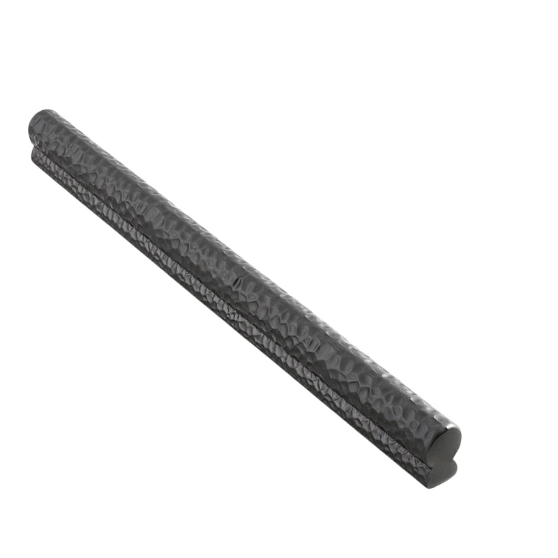 "Black hammered texture pull bar handle isolated on a white background, showcasing its modern and handcrafted design."
