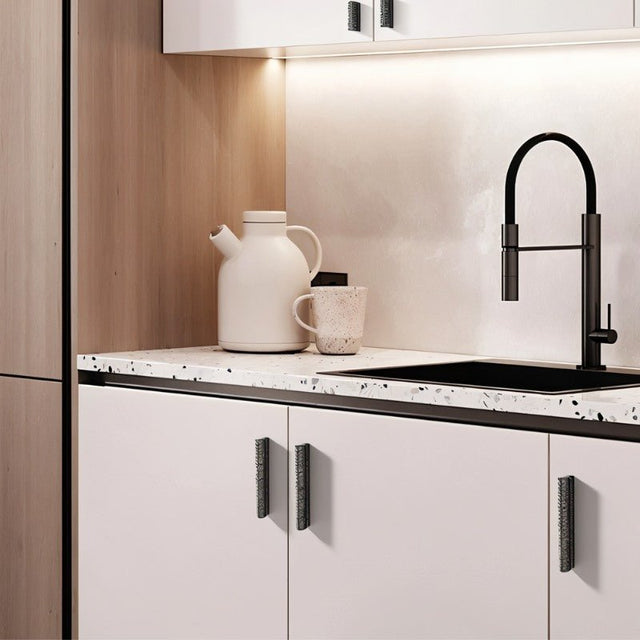 "Hammered texture pull bar handles on white kitchen cabinets, complementing a modern and functional design."