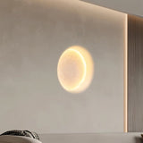 "A round, warm light effect on a wall, created by a recessed trimless downlight, resembling a moon."
