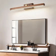 "A modern copper and walnut wall lamp with a linear design, mounted above a rectangular mirror in a contemporary bathroom with dual sinks."