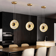Zunel Pendant Light – Copper & Crystal Elegance trio in a sleek kitchen, offering ambient lighting above a marble island.