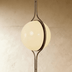 Modern brass pendant light with spherical shade, polished finish, shown in front and side view against white background with