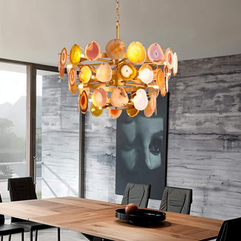 "Gold metal Zylan chandelier with layered circular design and natural agate slices in warm tones, hanging above a dining table."