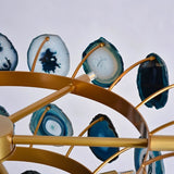 "Detailed view of the gold metal frame and blue agate slices of the Zylan chandelier."