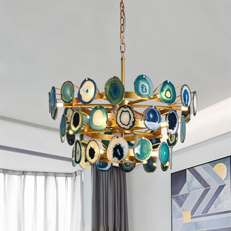 "Gold metal Zylan chandelier with layered circular design and natural agate slices, casting warm hues."