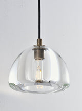 "A modern wall lamp with a clear glass shade, featuring a visible bulb and a black cord."