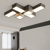 "A dark-colored geometric ceiling light with interlocking rectangular forms, providing diffused illumination in a modern interior."