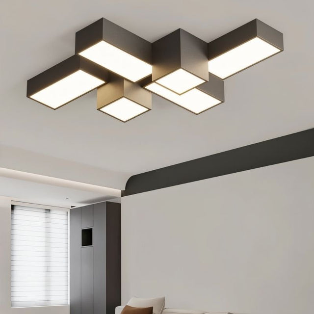 "A dark-colored geometric ceiling light with interlocking rectangular forms, providing diffused illumination in a modern interior."