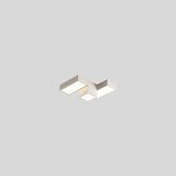 "A light-colored geometric ceiling light with interlocking rectangular forms, isolated against a neutral background, showcasing its modern design."