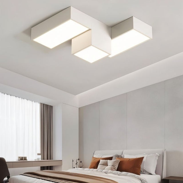 "A modern geometric ceiling light with interlocking rectangular forms, providing diffused lighting in a contemporary bedroom."