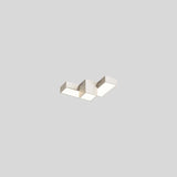 "A white geometric ceiling light with interlocking rectangular forms, isolated against a neutral background, showcasing its modern design."