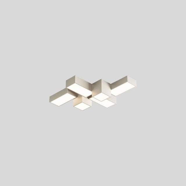 "A white multi-piece geometric ceiling light with interlocking rectangular forms, isolated against a neutral background, showcasing its modern design."