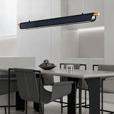 "Black modern pendant light with gold accents hanging over a dining table in a contemporary dining room."