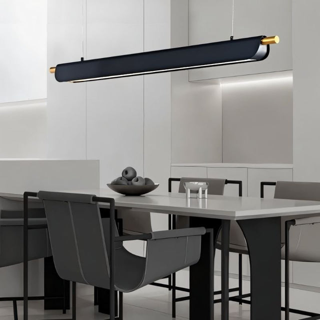 "Black modern pendant light with gold accents hanging over a dining table in a contemporary dining room."