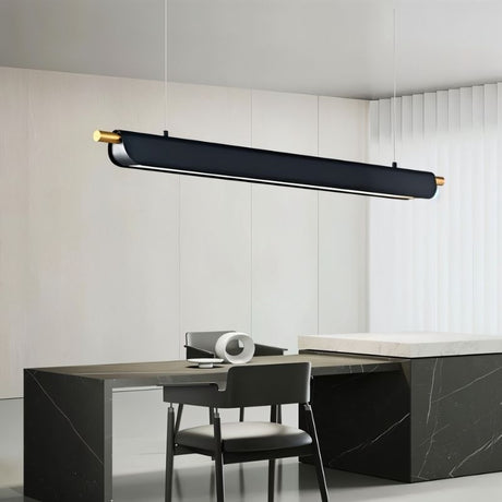 "Black modern pendant light with gold accents hanging in a contemporary kitchen with a dark countertop."